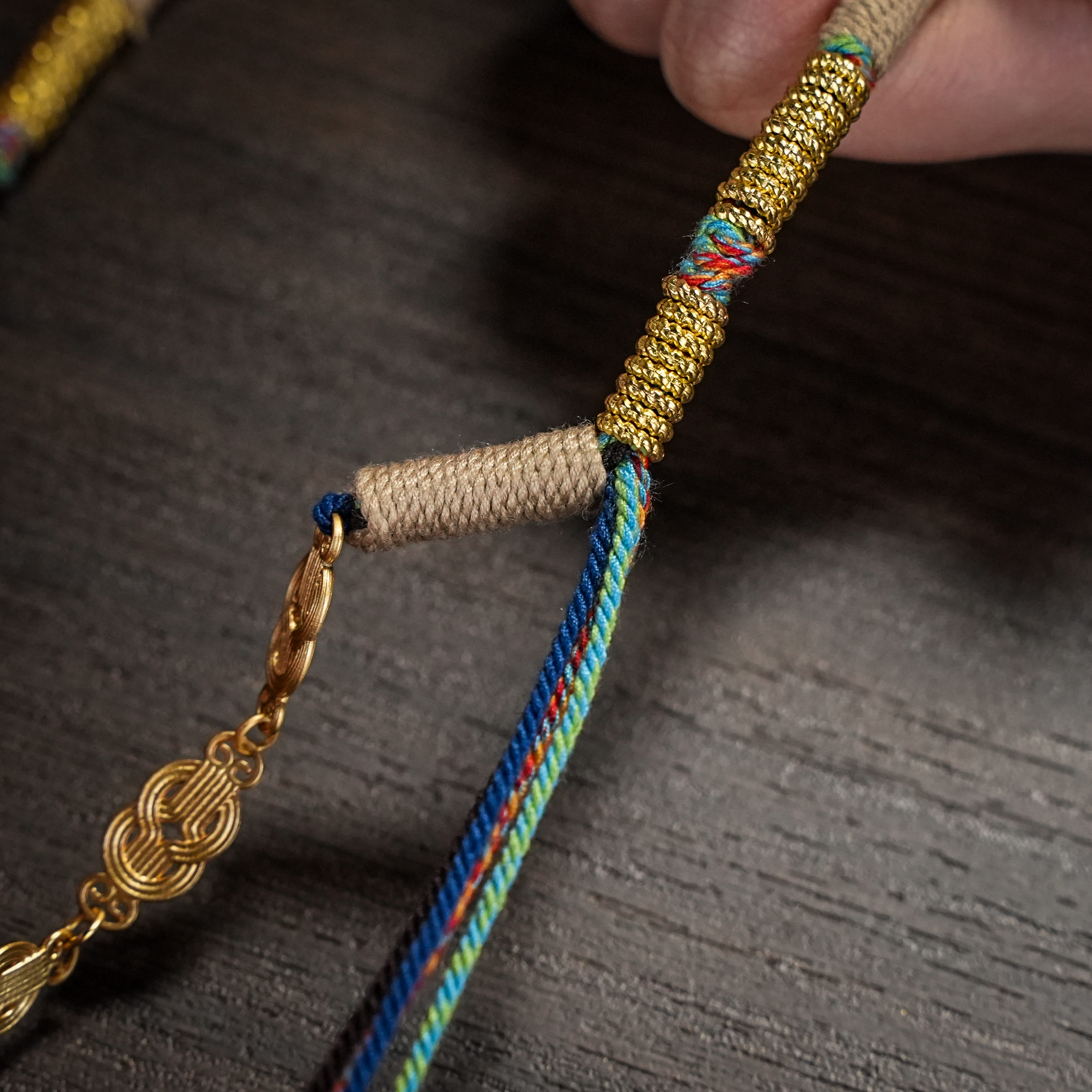 Close detail of brass engraving and braided cord fitting