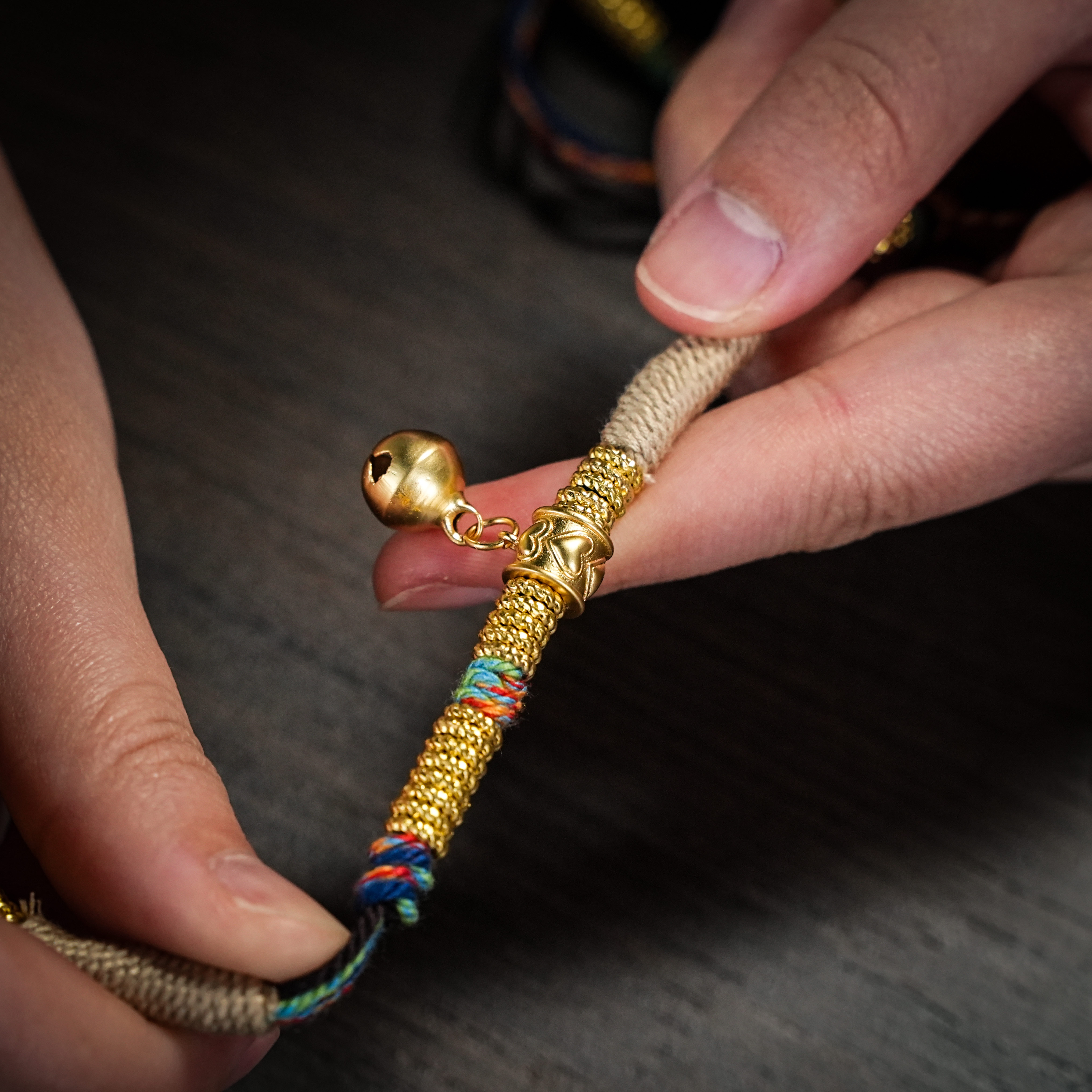 Thangka gau pendant held in a hand showing its scale
